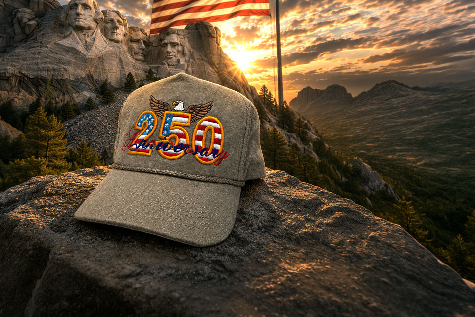 Cap with '250' design on Mount Rushmore at sunset